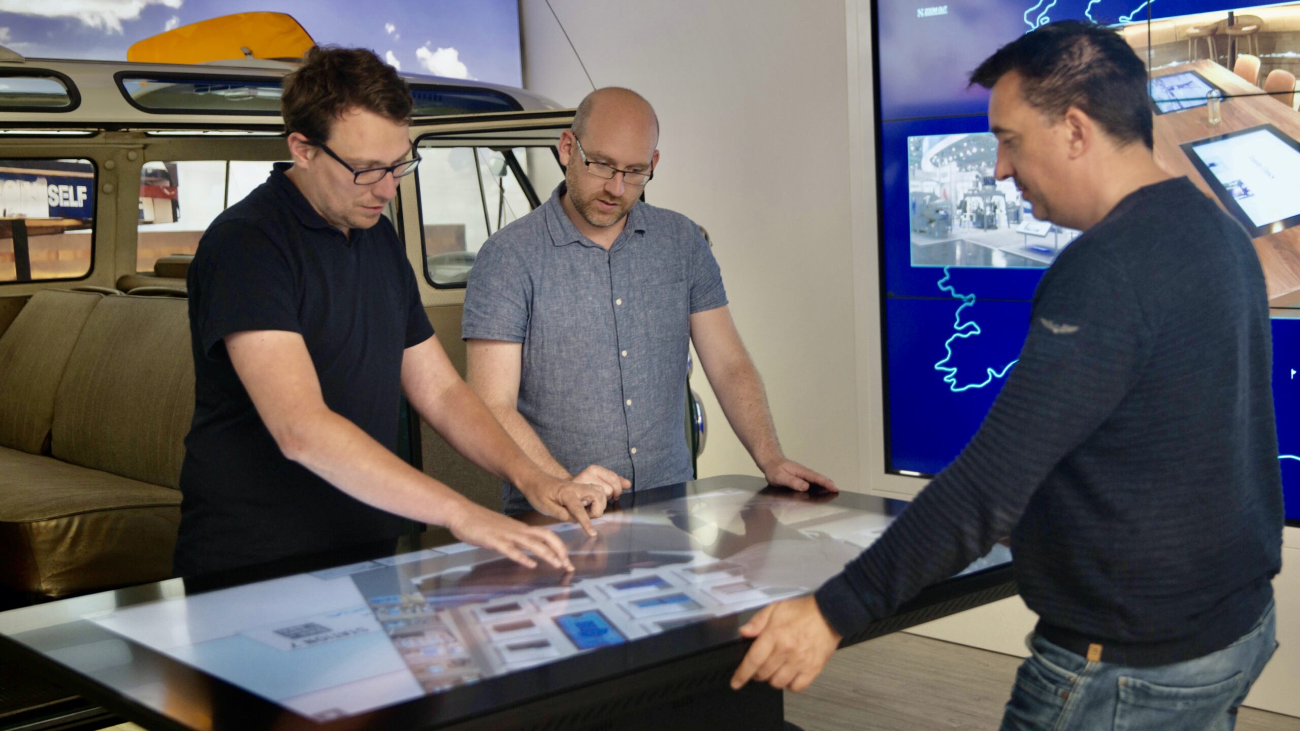 3 men at touchtable